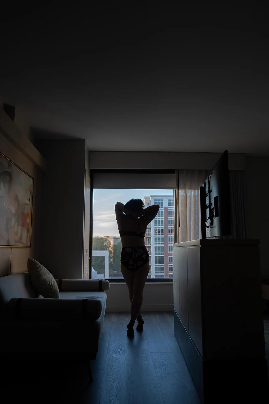 Silhouette portrait beside a window